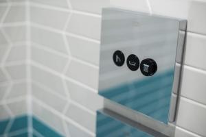 a glass shower door with a pair of blackuds at Juliot 5 Star Gold Award Luxury Cottage in St Ives