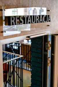 a sign for a restaurant on top of a building at Stay inn Hotel Gdańsk in Gdańsk