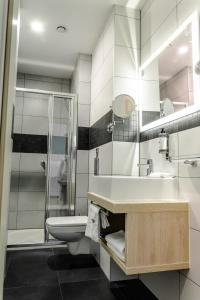 a bathroom with a sink and a toilet and a shower at Stay inn Hotel Gdańsk in Gdańsk