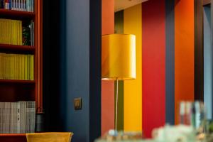 a lamp in the corner of a room with colorful walls at The Lion's Den BnB in Trieste