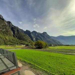 a view of a green field with mountains in the background at Agriturismo Summus Lacus in Riva