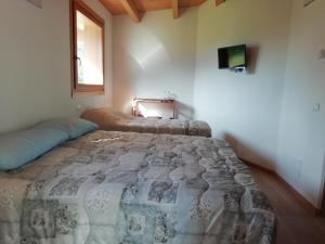 a bedroom with a bed and a television in it at Agriturismo Summus Lacus in Riva