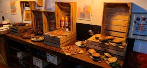 a table with many different types of food on it at Greg&Tom Beer House Hostel in Krakow