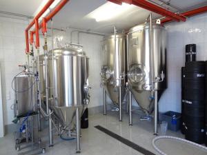 a brewery with three wine tanks in a room at Hirt's Brau-& Gasthof in Remptendorf