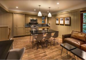 a kitchen and living room with a table and chairs at Cedar Crest - Sparrow Cottage 1 in Homewood