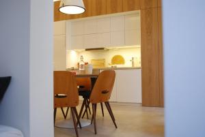 a kitchen with a table and chairs in a room at Stylish Studios Apartment in the City Center with Air Conditioning in Budapest