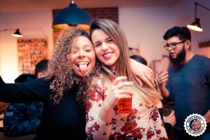 two women posing for a picture at a party at Greg&Tom Beer House Hostel in Krakow