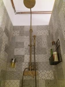 a shower in a bathroom with a tiled floor at Les Magranes Bed & Breakfast in Argelaguer