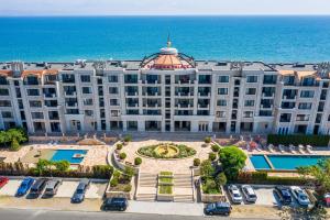 an aerial view of a hotel with the ocean in the background at Gardenia Beach Palace Aparthotel in Pomorie