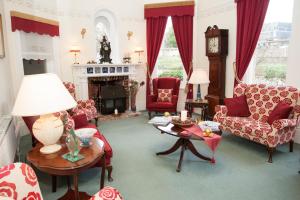 a living room with red furniture and a fireplace at Foxhills of Shanklin in Shanklin