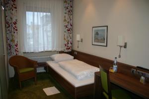 Postel nebo postele na pokoji v ubytování Hotel Hauser an der Universität