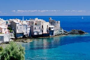 a group of houses on the shore of the water at Studio pied dans l’eau CAP CORSE ERBALUNGA in Brando