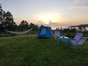 uma tenda e duas cadeiras e uma mesa e uma tenda em Leite Telt Camping em Lyngstad