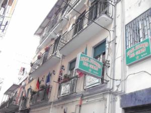 a building with street signs on the side of it at Hotel Alloggio Del Conte in Naples