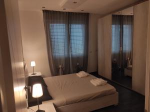 a bedroom with a bed and a large mirror at LA TERRAZZA in Falconara Marittima