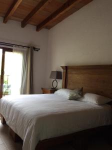 Postel nebo postele na pokoji v ubytování Hotel Concierge Flor y Canto
