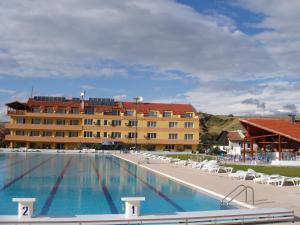 a large swimming pool in front of a building at Komitite Complex in Chuchuligovo