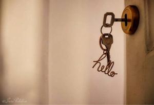 a towel dispenser hanging on a wall with the word hell at Bianko EcoChic & L'Angolo di Levante in Enna