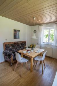 een eetkamer met een houten tafel en stoelen bij Haus Hirt - Idyllisch wohnen zwischen Augsburg und München in Klosterlechfeld +17 foto's