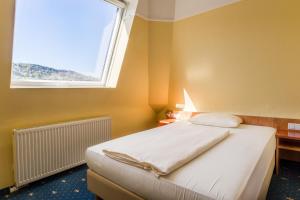 Postel nebo postele na pokoji v ubytování Aparthotel Astro - Nichtraucherhotel