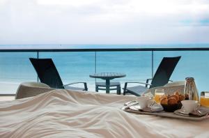 a table with a tray of food and a view of the ocean at Oceania Saint Malo in Saint Malo