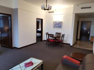a living room and dining room with a table and chairs at Elias KL 2 Bedroom Suite Times Square Bukit Bintang in Kuala Lumpur