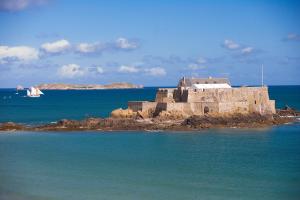 an old building on an island in the water at Oceania Saint Malo in Saint Malo