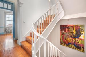una escalera en una casa con una pintura en la pared en Own Places Clérigos Apartments, en Oporto