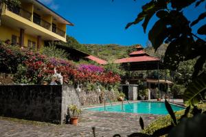 a view of a resort with a swimming pool at The Golden Frog Inn in Valle de Anton