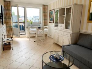 a living room with a couch and a table at Ostseehaus Dreesen in Timmendorfer Strand