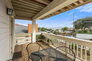 a porch with two chairs and a table at Spectacular Views - Walk to Cannery Row and the Aquarium in Pacific Grove