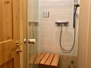 a bathroom with a shower with a bench in it at Chalet Bormino 5 in Bormio