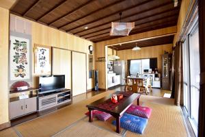 a living room with a couch and a tv at Nago - House - Vacation STAY 88505 in Nago