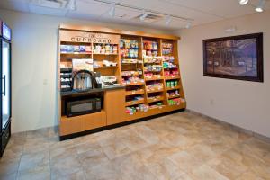 a store aisle with a coffee shop with a counter at Candlewood Suites Radcliff - Fort Knox, an IHG Hotel in Radcliff