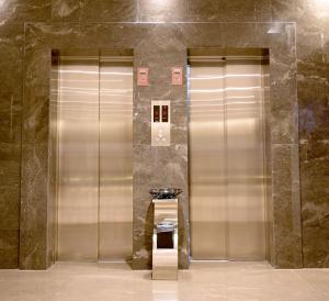 two elevators in a building with a sink in it at Sela Hotel فندق صلة in Medina
