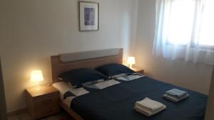 Posteľ alebo postele v izbe v ubytovaní Apartmani Mia