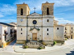 an old stone church with a clock tower at Apartaments Chenin Blanc-Priorat- in Cornudella