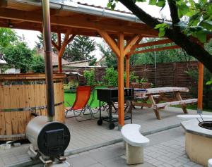 a patio with a grill and a picnic table at Apollo Vendégház in Edelény