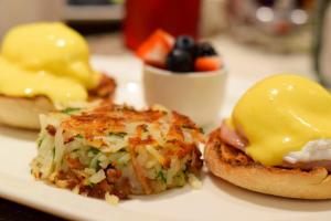 a plate with two breakfast sandwiches with cheese and vegetables at InterContinental Cleveland, an IHG Hotel in Cleveland