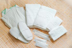 a pile of white towels on a table at Reisenkaku Hotel Ekimae in Fukuoka +49 photos