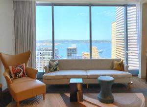 a living room with a couch and a large window at Lotte Hotel Seattle in Seattle