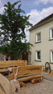 a wooden bench sitting in front of a house at Urlaub auf dem Bauernhof,Landurlaub,Ferienwohnung in Gränze