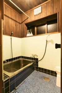 a bathroom with a bath tub and a toilet at Kumage-gun - House - Vacation STAY 89468 in Yudomari