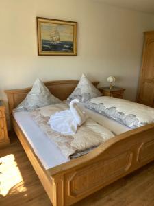 a wooden bed in a bedroom with a picture on the wall at Luxus FeWo - Spannagl in Pocking