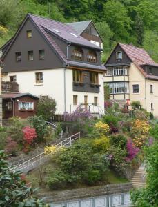 un grupo de casas en una colina con flores en Ferienwohnung Morgensonne Kurort Rathen en Rathen
