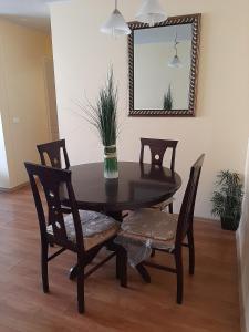 a dining room table with two chairs and a mirror at Departamento Amueblado in Antofagasta