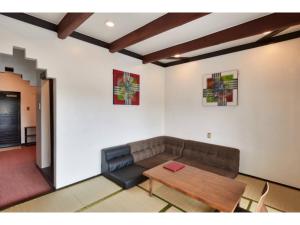 a living room with a couch and a table at Kunigami-gun - Hotel - Vacation STAY 89680 in Inbu