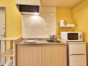 a small kitchen with a sink and a microwave at Kunigami-gun - Hotel - Vacation STAY 89678 in Inbu