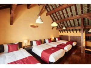 a group of four beds in a room at Kunigami-gun - Hotel - Vacation STAY 89682 in Inbu