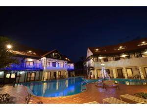 a building with a swimming pool at night at Kunigami-gun - Hotel - Vacation STAY 89682 in Inbu
